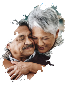 Woman with light brown skin and short grey hair hugging man with light brown skin and dark grey mustache